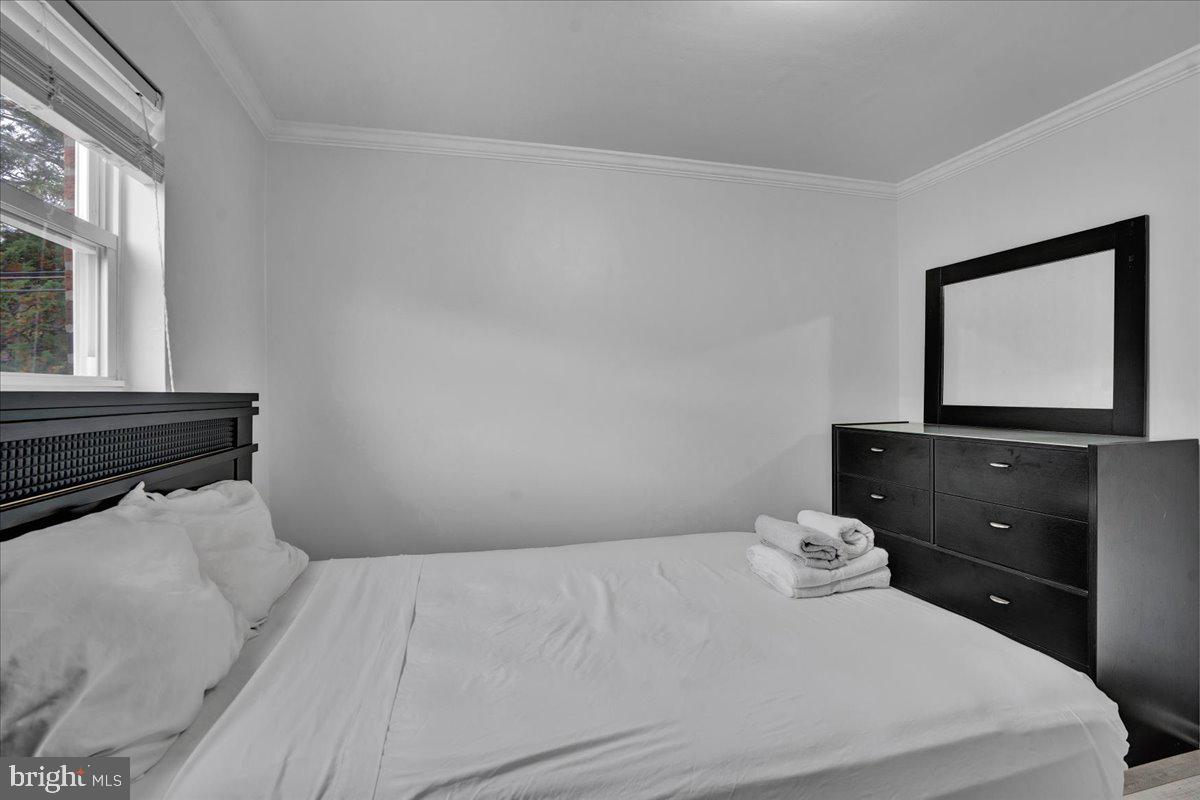 1952 Goodnaw Street, Unit 2 Philadelphia, PA 19115 - Photo 22 of 26 a bedroom with a bed and a flat screen tv