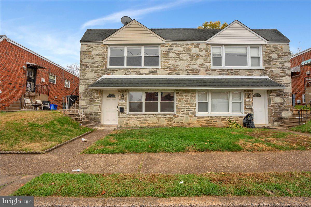1952 Goodnaw Street, Unit 2 Philadelphia, PA 19115 - Photo 23 of 26 a front view of a house with a yard
