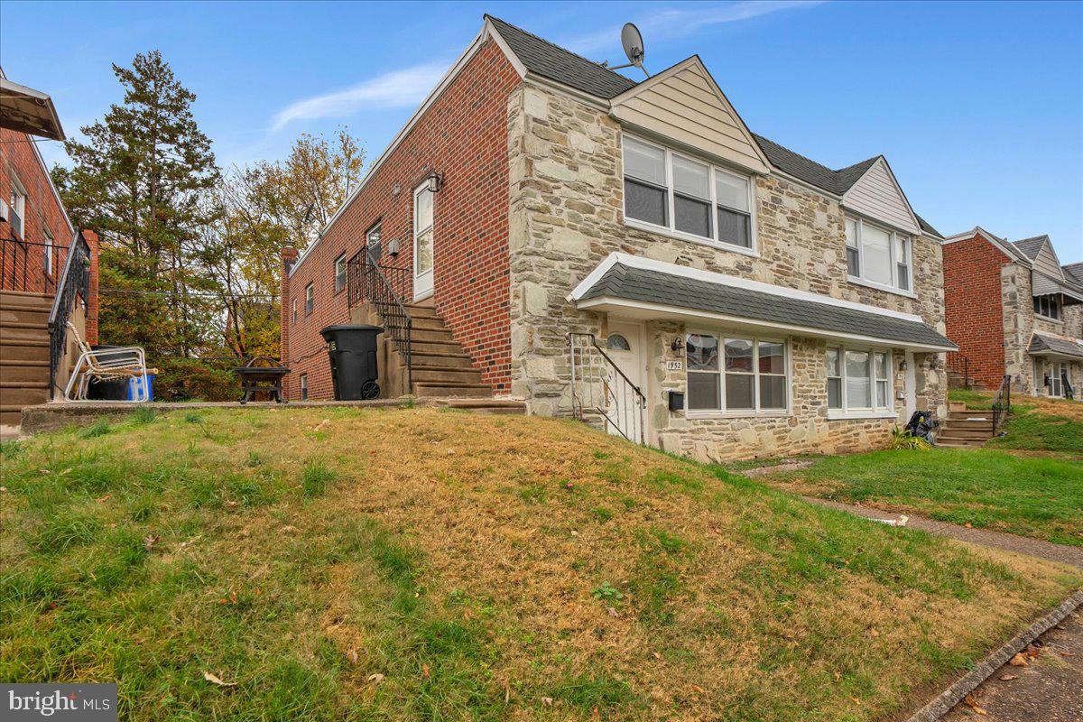 1952 Goodnaw Street, Unit 2 Philadelphia, PA 19115 - Photo 24 of 26 a front view of house with yard