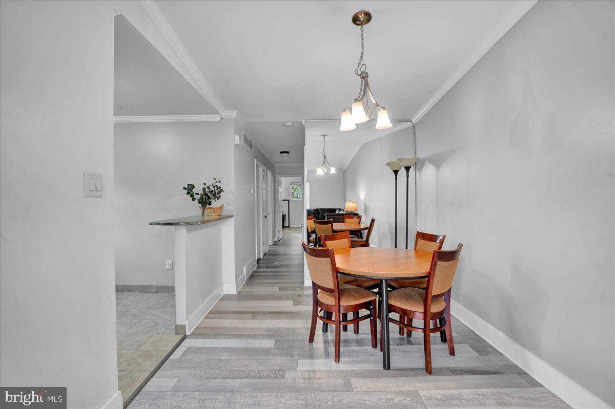 1952 Goodnaw Street, Unit 2 Philadelphia, PA 19115 - Photo 6 of 26 a view of a dining room with furniture and wooden floor