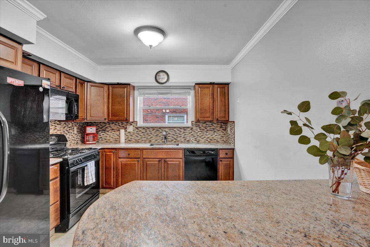 1952 Goodnaw Street, Unit 2 Philadelphia, PA 19115 - Photo 7 of 26 a kitchen with stainless steel appliances granite countertop sink stove and refrigerator