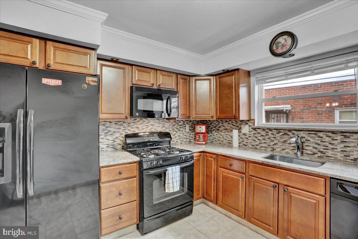 1952 Goodnaw Street, Unit 2 Philadelphia, PA 19115 - Photo 8 of 26 a kitchen with stainless steel appliances granite countertop a sink stove and refrigerator