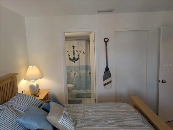 a bedroom with a bed and a dresser