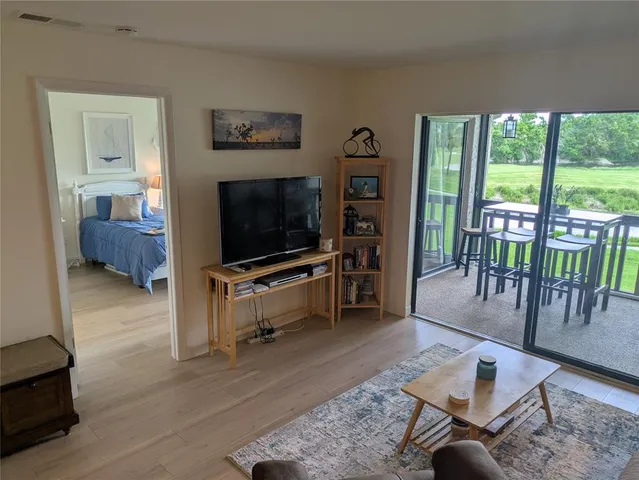 a bedroom with two beds and large window