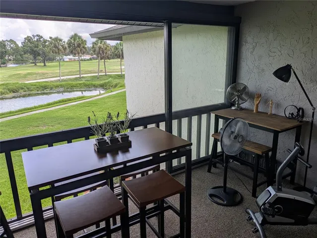 a view of a balcony and floor to ceiling windows