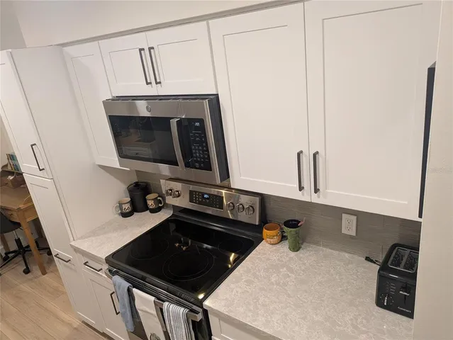 a kitchen with a sink appliances and cabinets
