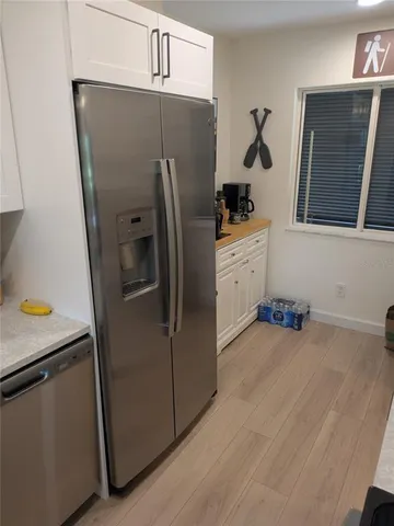 a kitchen with stainless steel appliances a refrigerator a sink a stove and cabinets