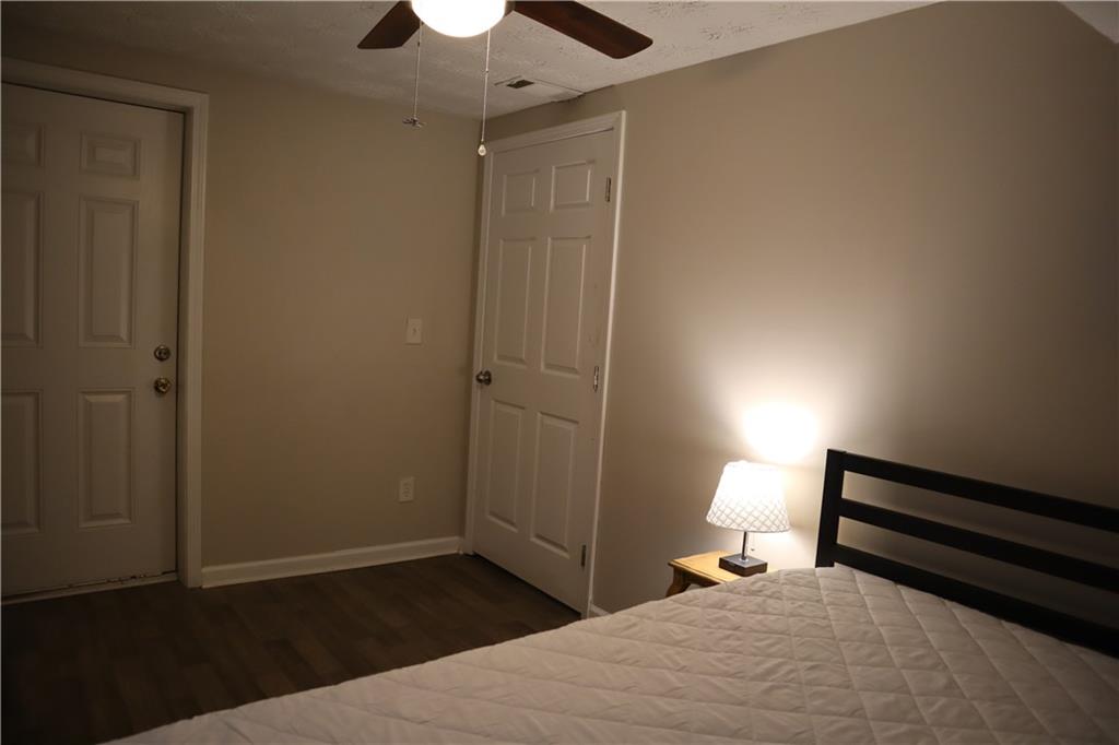 3033 Empire Boulevard Southwest Atlanta, GA 30354 - Photo 14 of 33 a bedroom with a bed and a chandelier