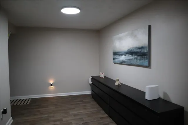 a view of a room with wooden floor