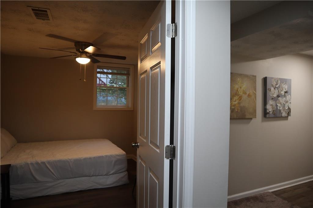 3033 Empire Boulevard Southwest Atlanta, GA 30354 - Photo 17 of 33 a bedroom with a bed and a chandelier