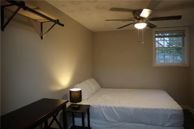 a bedroom with a bed and a lamp on the table