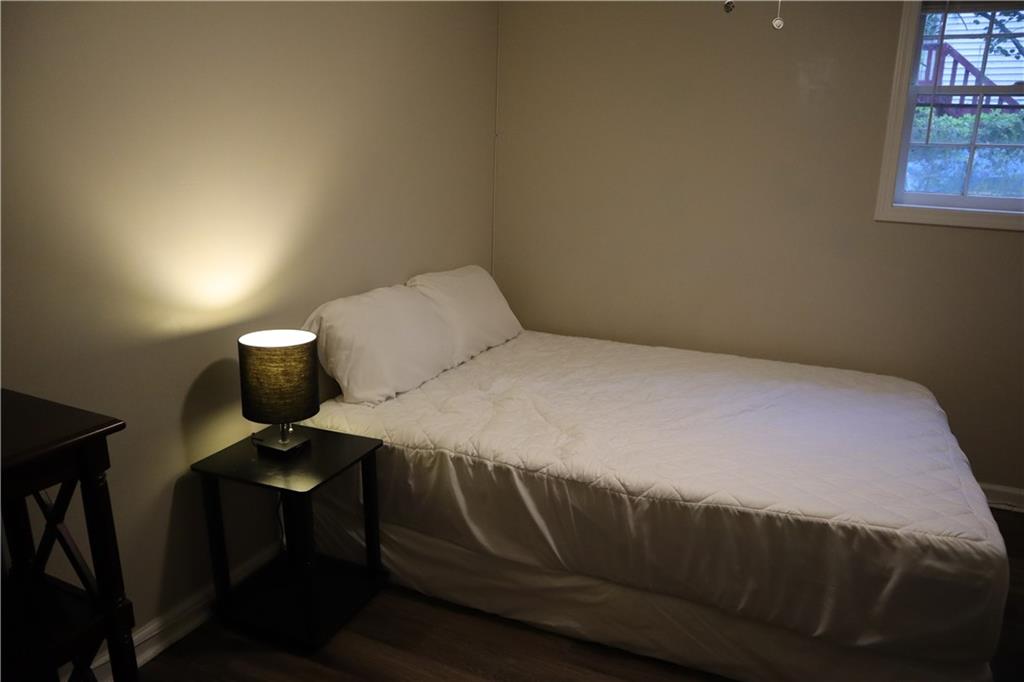 3033 Empire Boulevard Southwest Atlanta, GA 30354 - Photo 20 of 33 a bedroom with a bed and a lamp on table