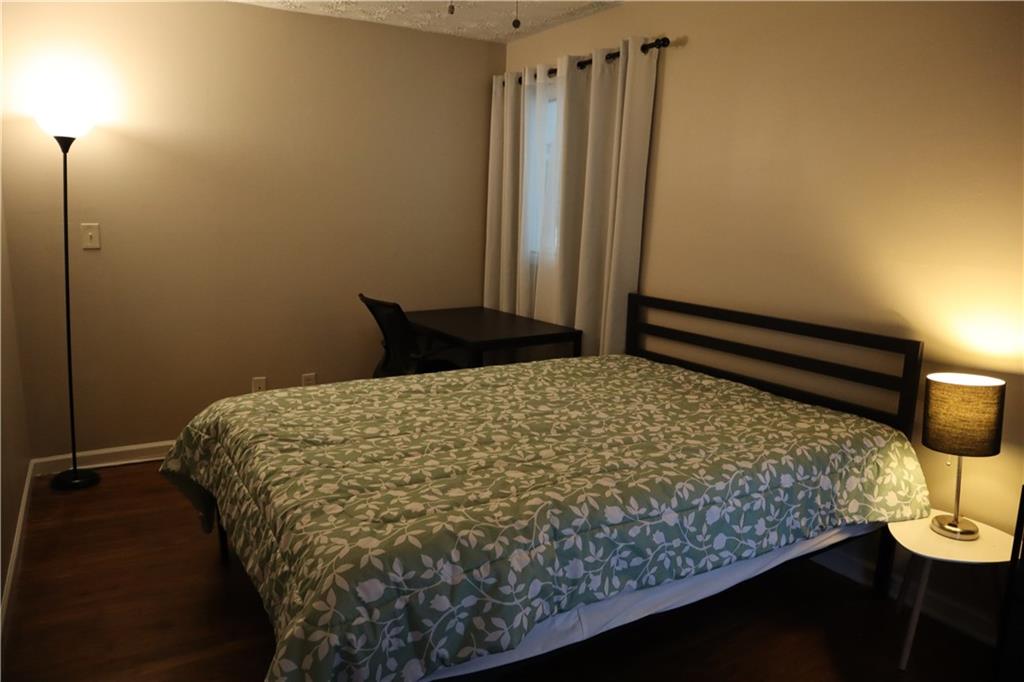 3033 Empire Boulevard Southwest Atlanta, GA 30354 - Photo 21 of 33 a bed sitting in a bedroom next to a window