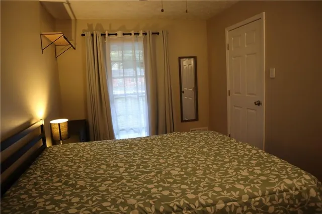 a bedroom with a bed and a view of bathroom