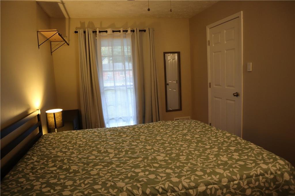 3033 Empire Boulevard Southwest Atlanta, GA 30354 - Photo 23 of 33 a bedroom with a bed and a view of bathroom