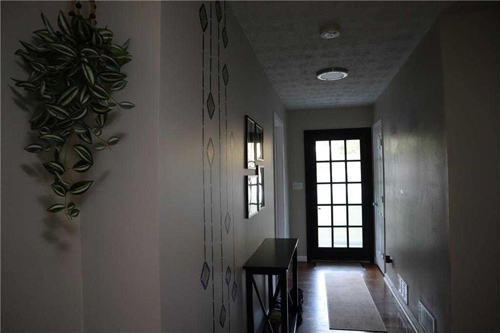 3033 Empire Boulevard Southwest Atlanta, GA 30354 - Photo 4 of 33 wooden floor in an empty room with a window