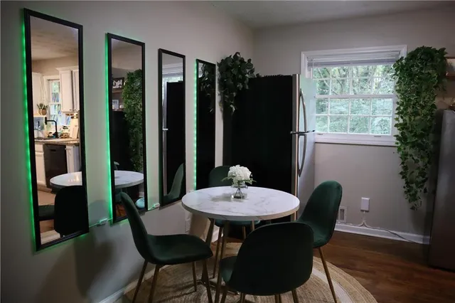a view of a dining room with furniture window and wooden floor