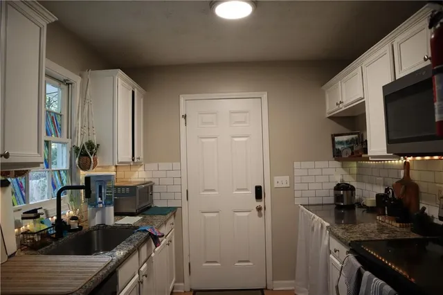 a kitchen with a sink cabinets and appliances