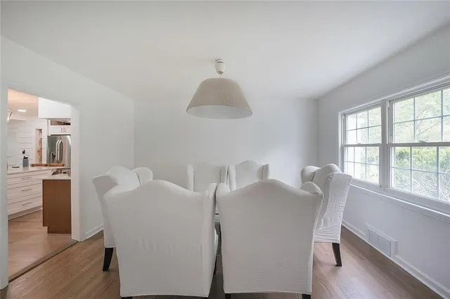 a view of a dining room with furniture and a window
