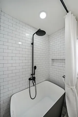 a bathroom with a shower and a bathtub