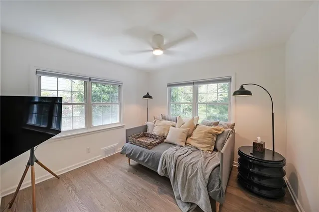 a bedroom with a bed and a large window