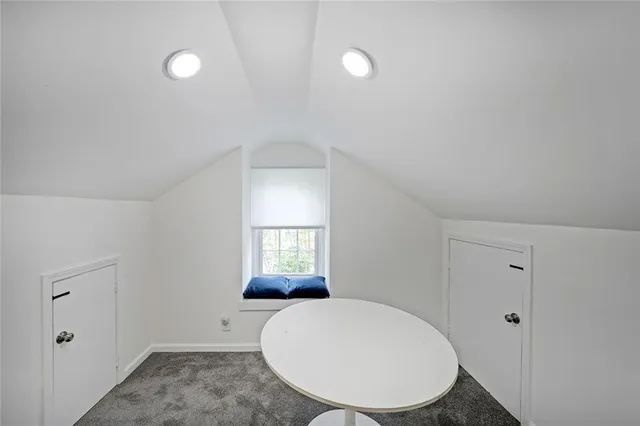 a view of a patio with table and chairs with wooden floor and fence
