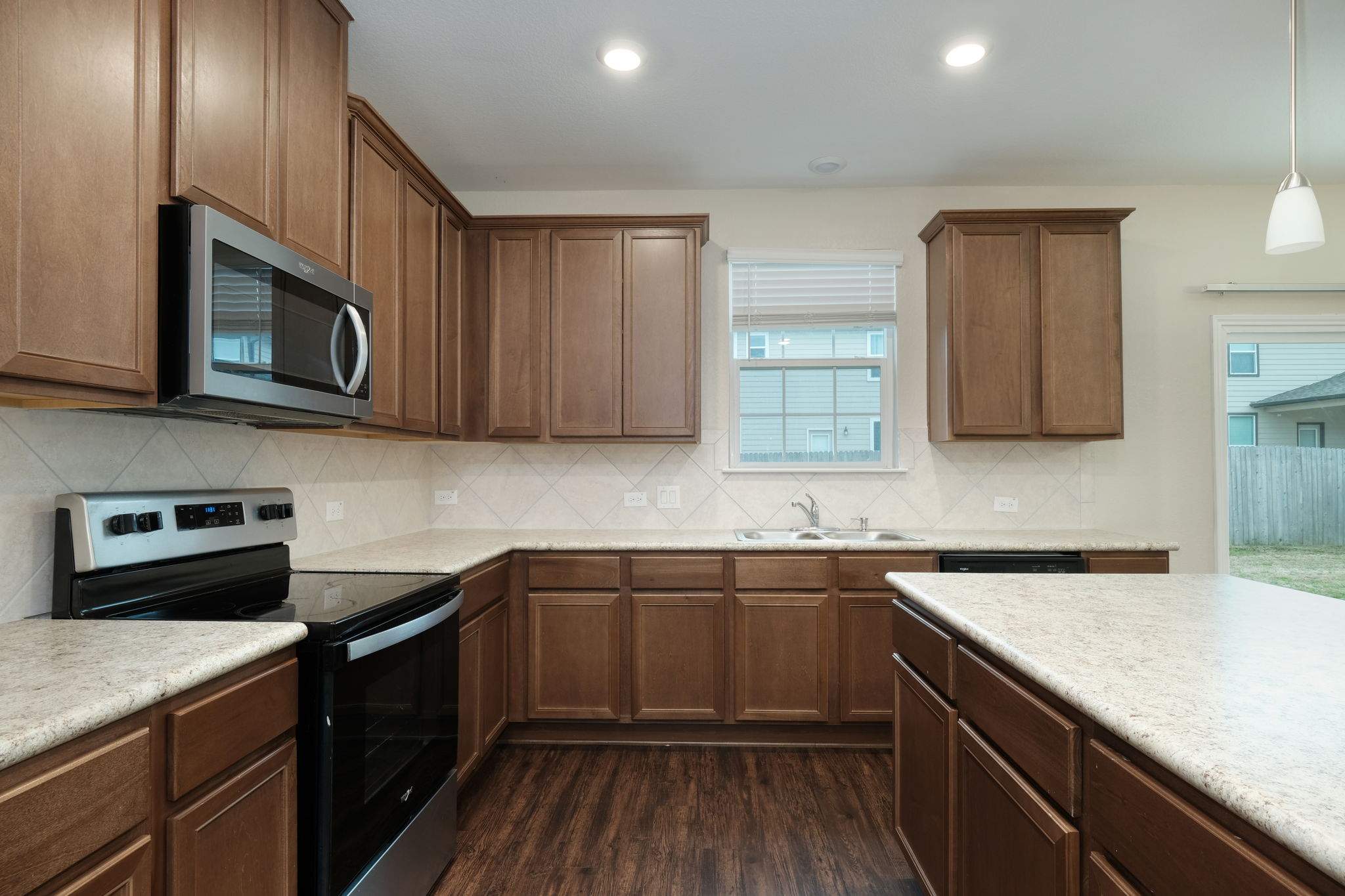 Rich wood cabinetry and ample counter space define this functional culinary workspace.