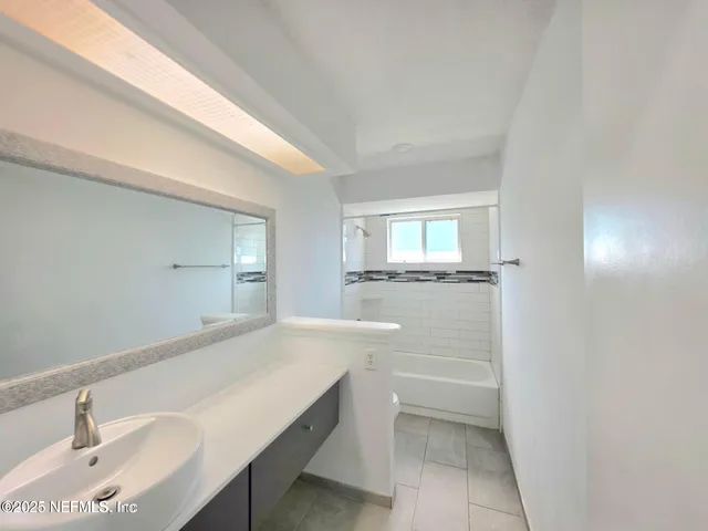 a bathroom with a sink a toilet and mirror