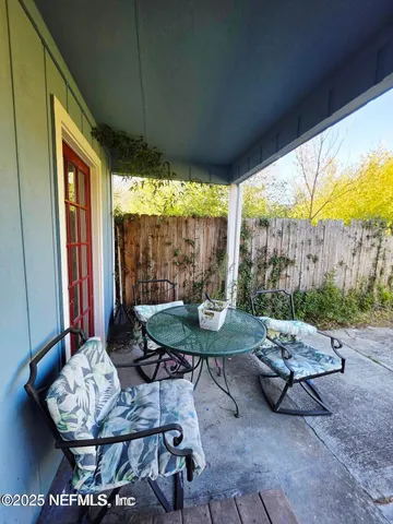 a backyard of a house with a fountain table and chairs
