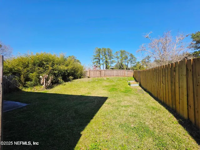 a view of a swimming pool with a yard