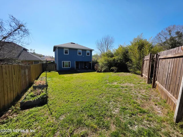 a view of a garden with a house