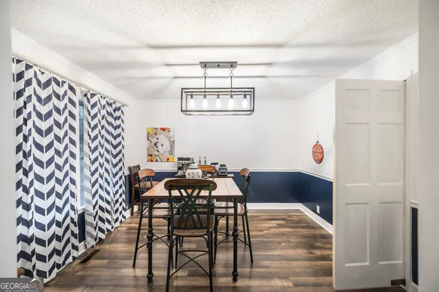 a view of a dining room with furniture and chandelier