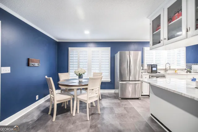 a dining room with furniture and window