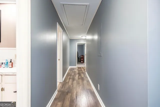 a view of a hallway with wooden floor