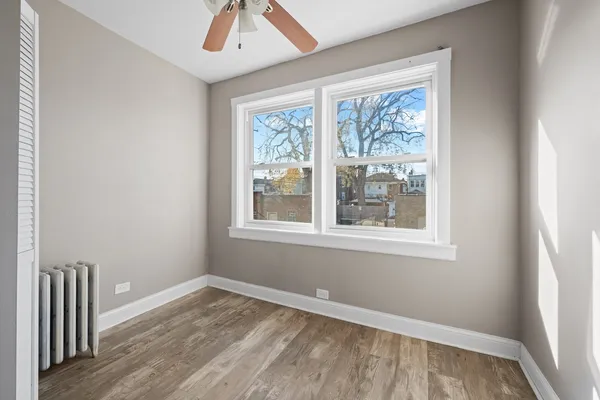 an empty room with wooden floor and a door