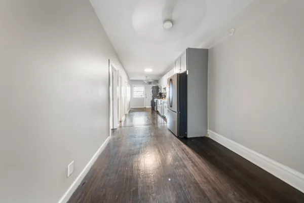 a view of a room with wooden floor and window