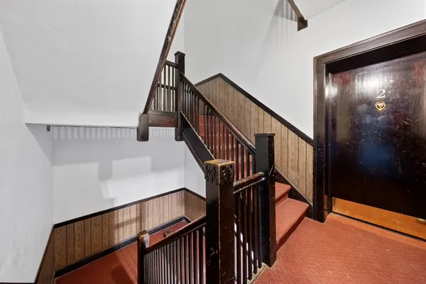a view of a kitchen with wooden floor and a refrigerator
