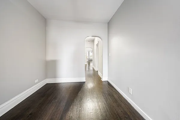 a view of a livingroom with wooden floor and a ceiling fan