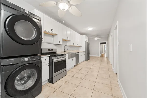 a hallway with a washer and dryer