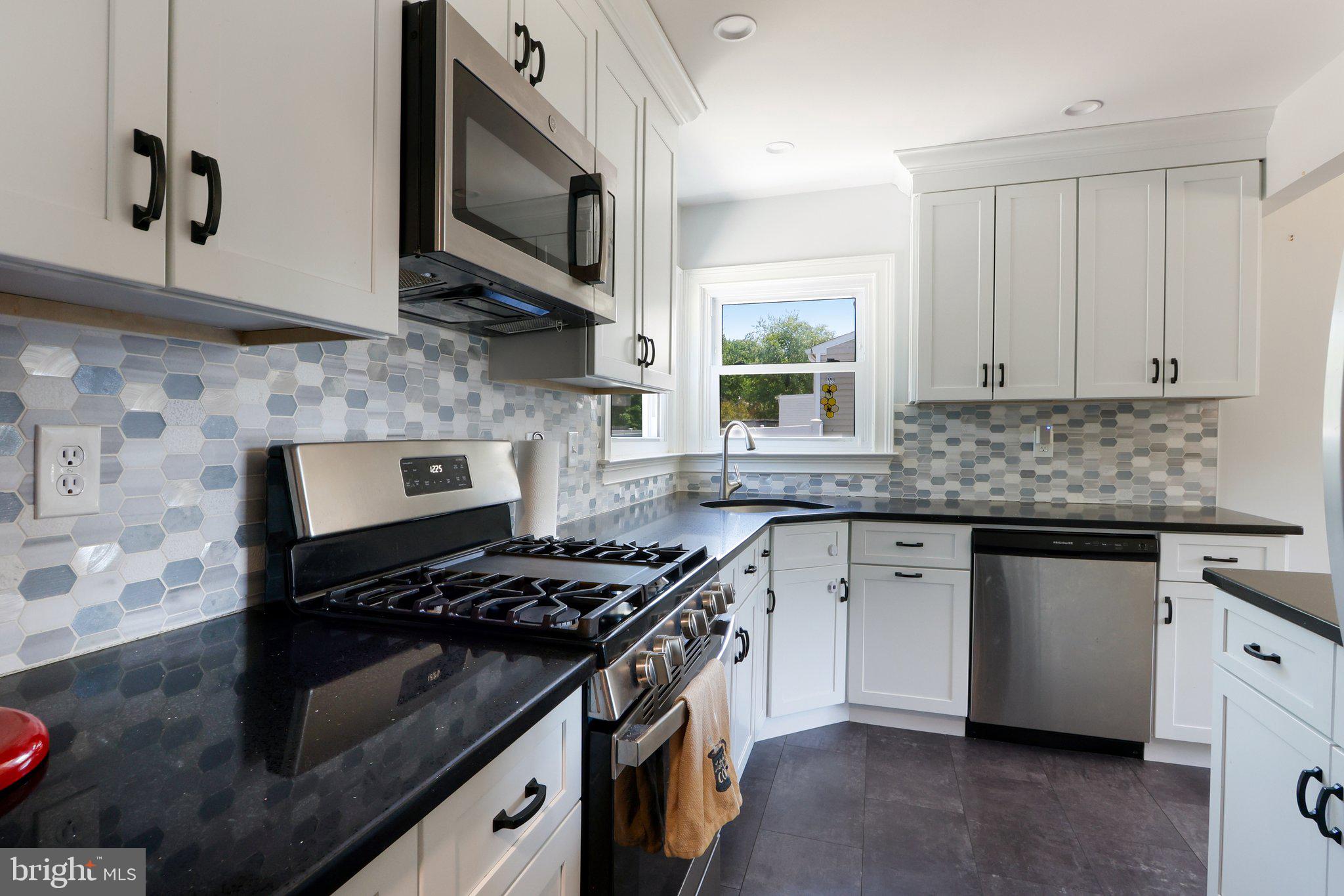 73 Burnt Tavern Road Brick, NJ 08724 - Photo 12 of 31 a kitchen with stainless steel appliances granite countertop a stove and a microwave