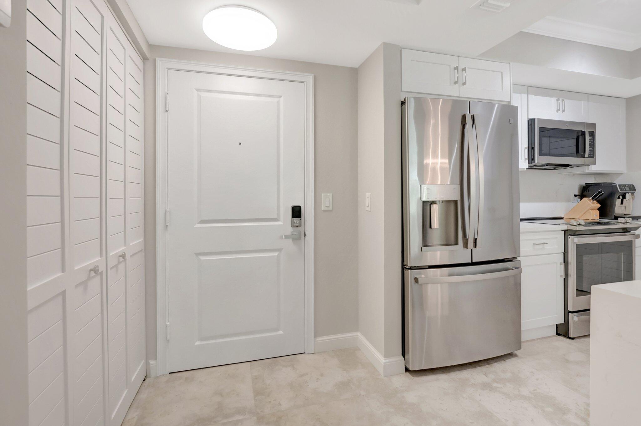 99 Southeast Mizner Boulevard, Unit 636 Boca Raton, FL 33432 - Photo 2 of 39 a kitchen with stainless steel appliances a refrigerator and a cabinets
