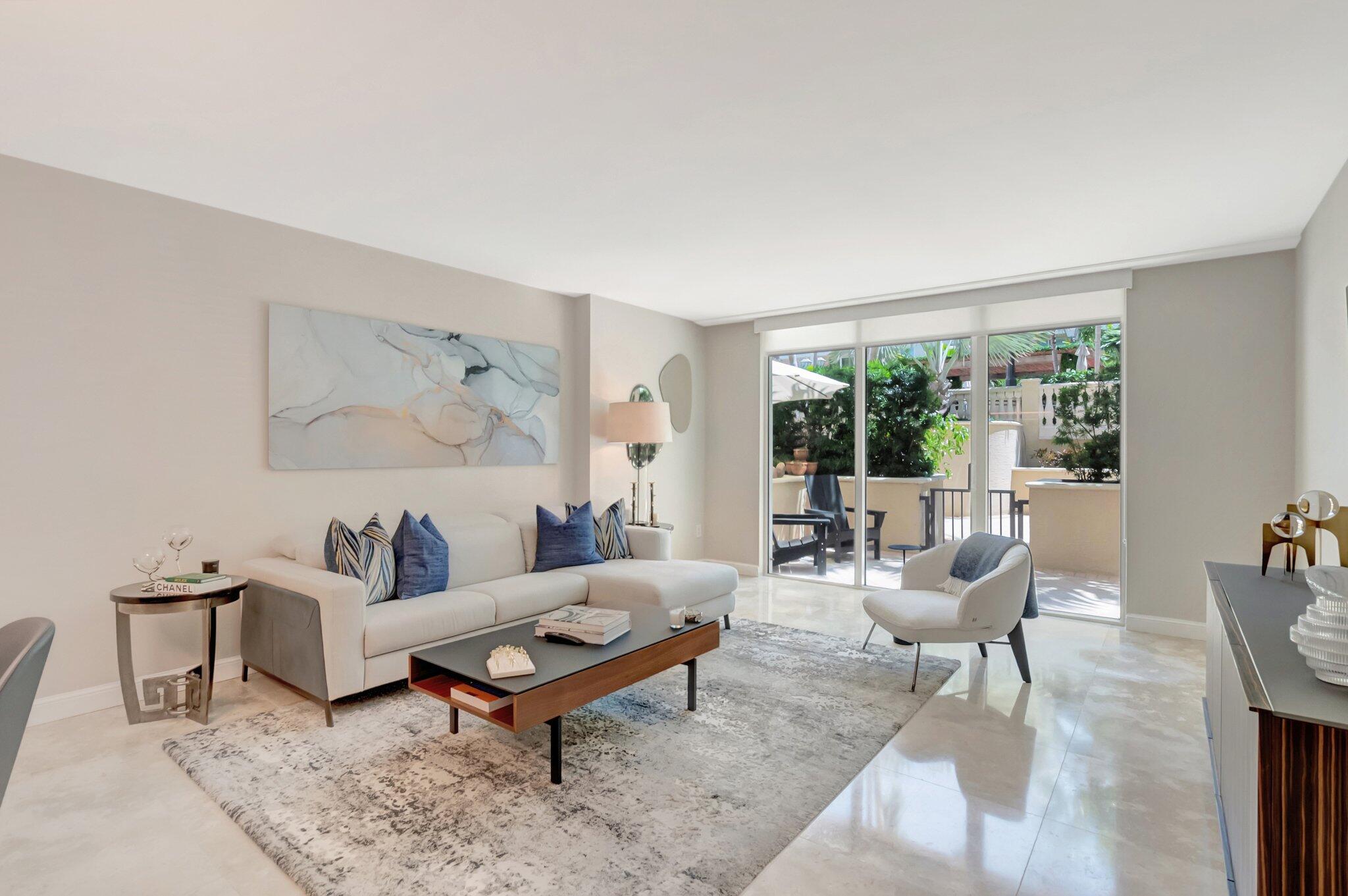 99 Southeast Mizner Boulevard, Unit 636 Boca Raton, FL 33432 - Photo 7 of 39 a living room with furniture and a large window