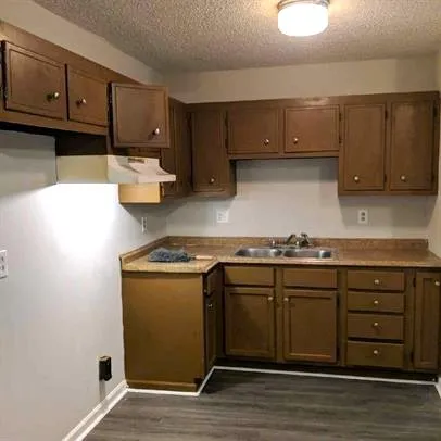 a kitchen with stainless steel appliances granite countertop a sink and a stove