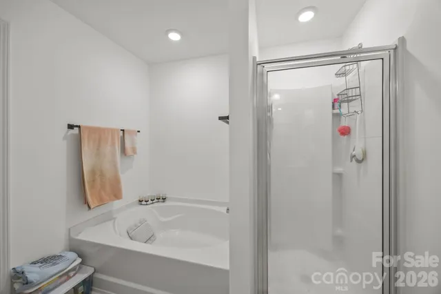 a bathroom with a shower and a tub
