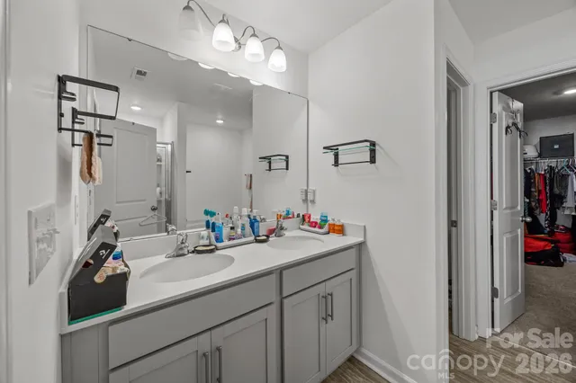 a bathroom with a sink vanity and a mirror