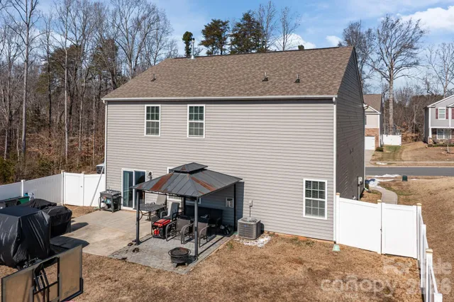 a view of house with backyard and seating area