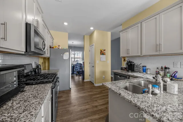 a kitchen with a sink stove and cabinets
