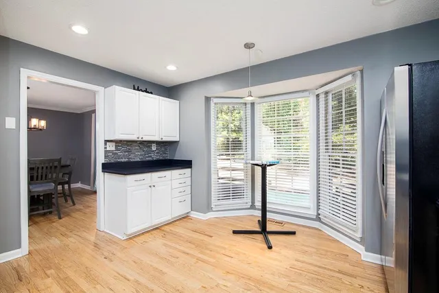 a kitchen with a refrigerator and a stove top oven