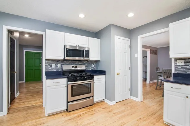 a kitchen with granite countertop a stove and a sink