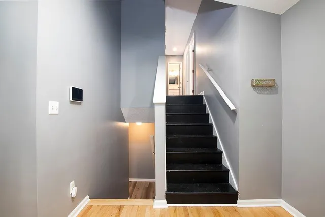 a view of entryway and hall with wooden floor